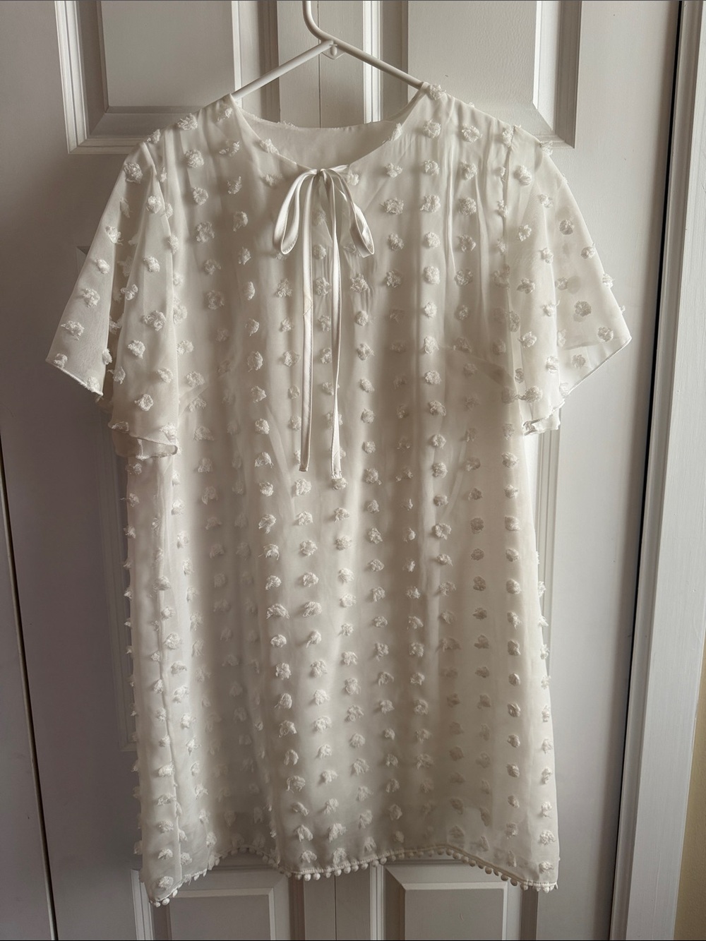 Ivory Swiss Dot Tie-Neck Mini Dress. 36 inches long.